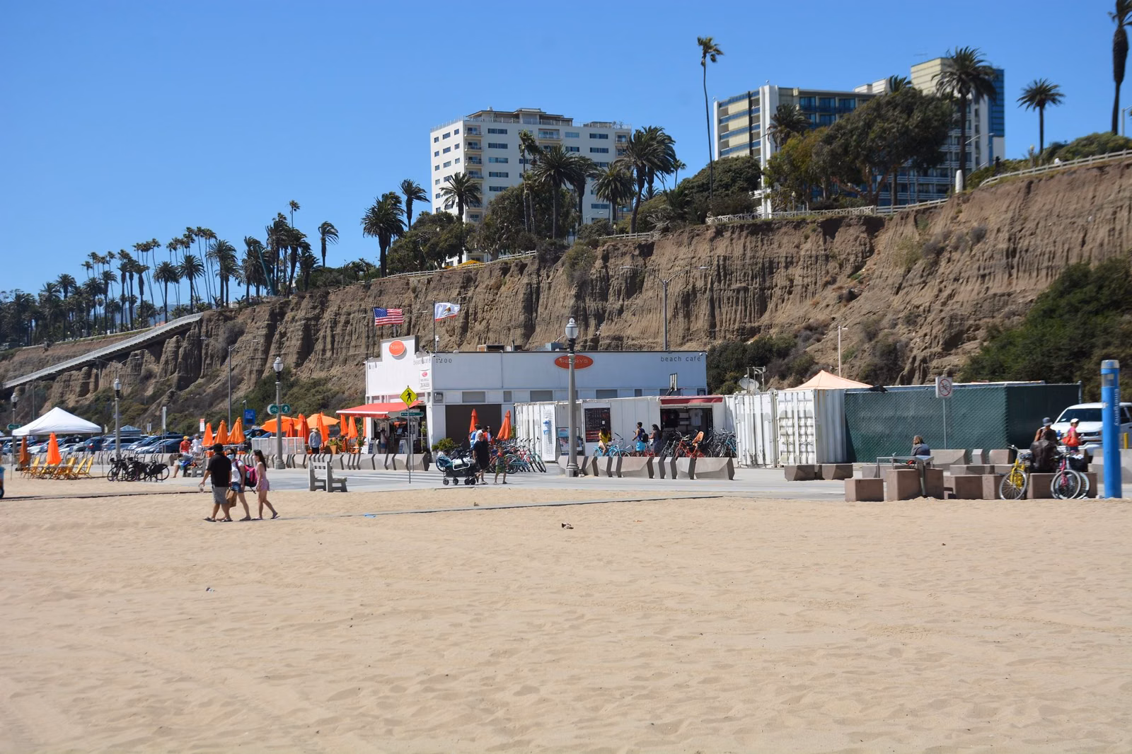 Santa Monica State Beach below the bluffs, with a beach snack stand and umbrellas