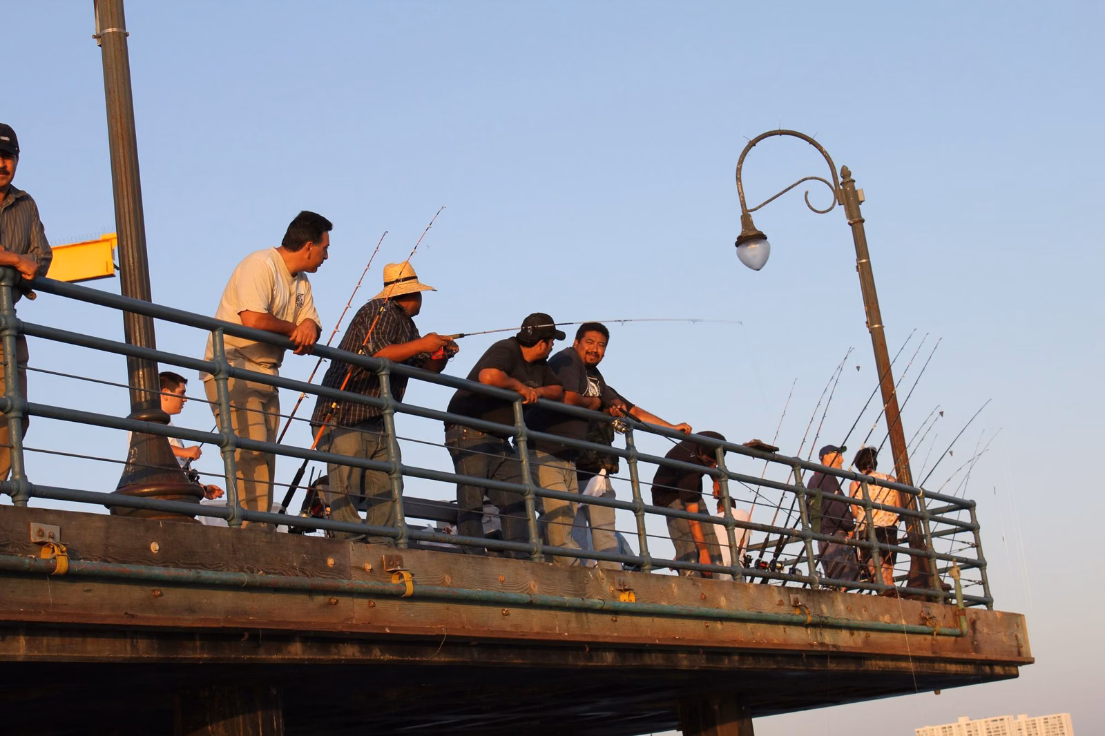 Anglers fishing over the railing on the Santa Monica Pier
